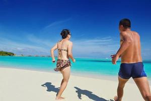 happy young  couple enjoying summer on beach photo