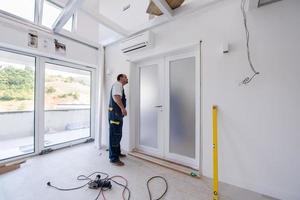 carpenters installing glass door with a wooden frame photo