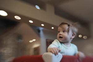 cute  little  baby playing in mobile  bed photo