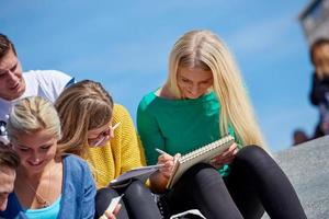 students outside sitting on steps photo