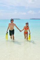 happy young couple have fun on beach photo