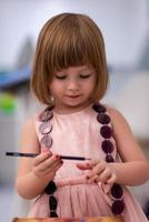 little girl painting jewelry box photo