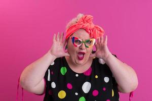 Happy Plus Size Woman Wearing Eyeglasses Smiling To Camera Standing Over Pink Background. Cheerful Millennial Female In Eyewear Posing In Studio. photo