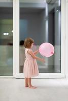 cute little girl playing with balloons photo