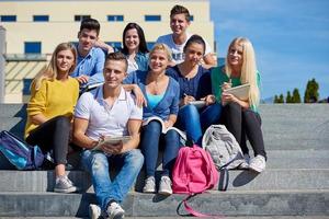 students outside sitting on steps photo