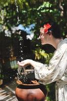 splashing fresh water on woman hands photo