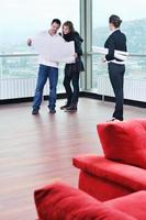 happy young couple buying new home with real estate agent photo