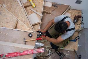 carpenter installing wooden stairs photo