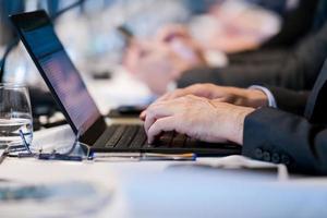 close up of business people hands using laptop computer photo