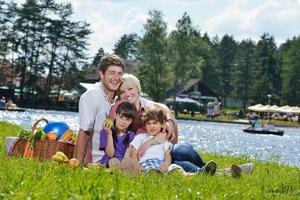 Happy family playing together in a picnic outdoors photo