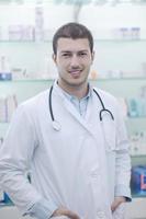 pharmacist chemist man in pharmacy drugstore photo