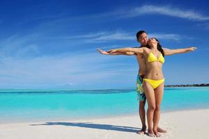 happy young  couple enjoying summer on beach photo