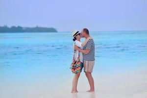 happy young couple have fun on beach photo