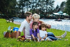 Happy family playing together in a picnic outdoors photo