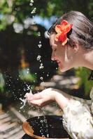 splashing fresh water on woman hands photo