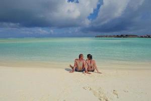 happy young couple have fun on beach photo