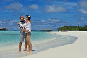 happy young couple have fun on beach photo