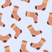 Cute warm socks. Seamless pattern in cartoon style. Vector illustration on blue background.