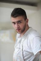 portrait of construction worker with dirty uniform in apartment photo