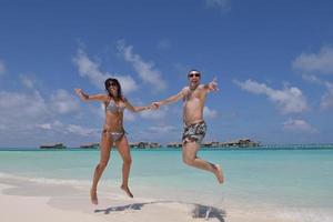 happy young couple have fun on beach photo