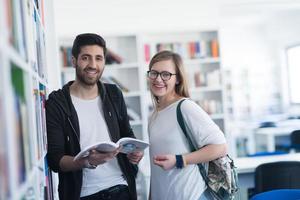 students couple  in school  library photo