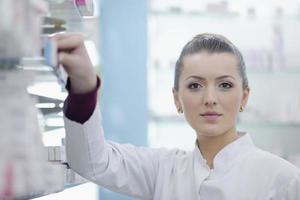 pharmacist chemist woman standing in pharmacy drugstore photo