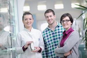 pharmacist suggesting medical drug to buyer in pharmacy drugstore photo