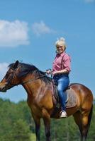 happy woman  on  horse photo