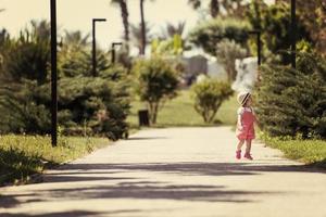 little girl runing in the summer Park photo