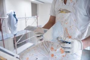 construction worker plastering on gypsum walls photo