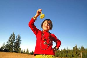 happy girl with grape outside photo