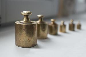 Antique set of metal weights in a row. photo