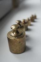 Antique set of metal weights in a row seen from above photo