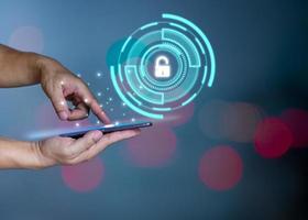 People's fingers are pressing on the phone screen. Represents protection against external hacks, code protection security concepts, viruses, firmware and malware. photo