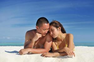 happy young  couple enjoying summer on beach photo