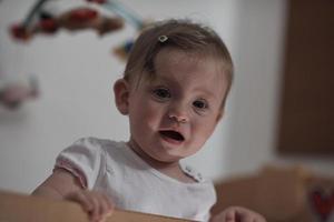 cute  little one year old baby and making first steps in bed photo