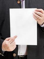 teacher holds blank sheet of paper in hands photo