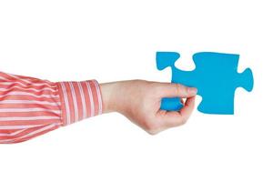 male hand holding big blue paper puzzle piece photo
