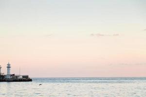 lighthouse and quiet Black Sea in evening, Yalta photo