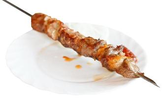 skewer of lamb shishkebab on white plate isolated photo