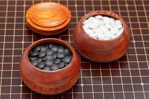 go game stones in wooden bowl photo