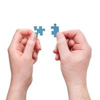 male and female hands with little puzzle pieces photo