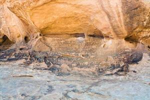 Petroglyphs on sandstone rock in Wadi Rum desert photo