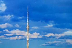 television tower with deep blue cloudy sky photo