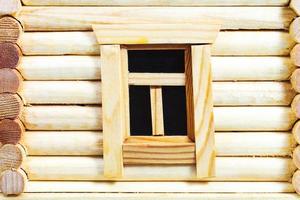 wall with window of wooden log house photo