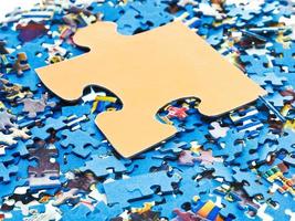 big piece on pile of disassembled puzzles photo