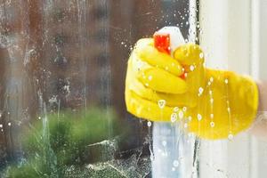 foamy liquid on window glass during washing photo