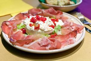 burrata cheese with parma prosciutto crudo photo