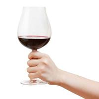 hand holds goblet glass with red wine photo