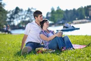 happy young couple having a picnic outdoor photo